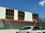 A building with a damaged roof after Hurricane Helene.