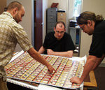 Alex, Wil, and Thomas check out the press sheet