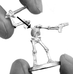 Attaching the second arm: the proper position to hold the figure